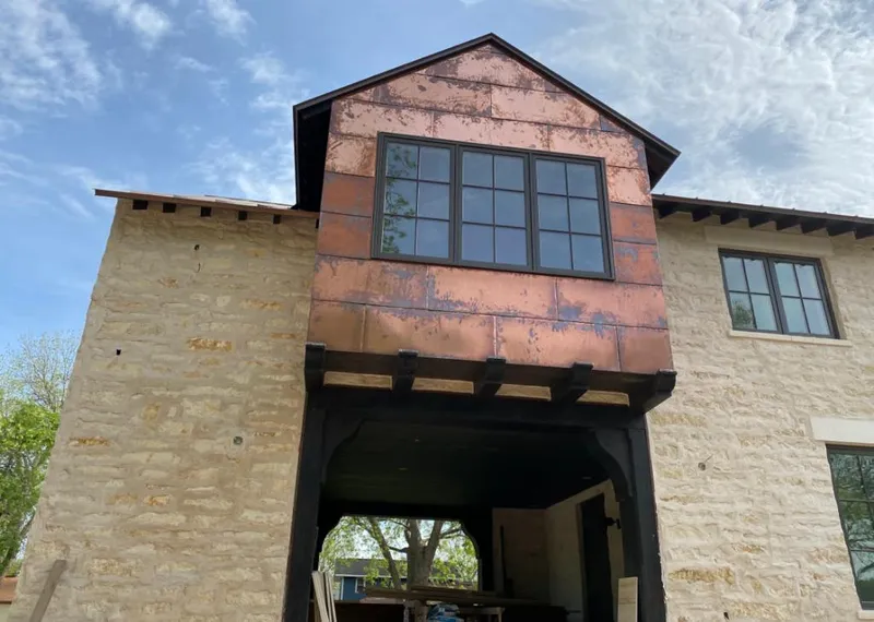 Copper metal panel facade on a stone building for Roof Repair in Waconia